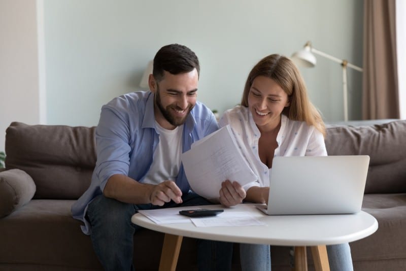 young couple calculating property tax together